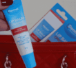 Lip Balm Original near a red handbag