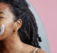 Woman with dreadlocks using Dermal Therapy Acne Face Wash Lotion