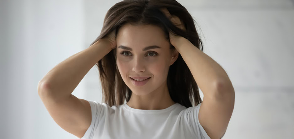 Young woman enjoying the benefits of a healthy scalp