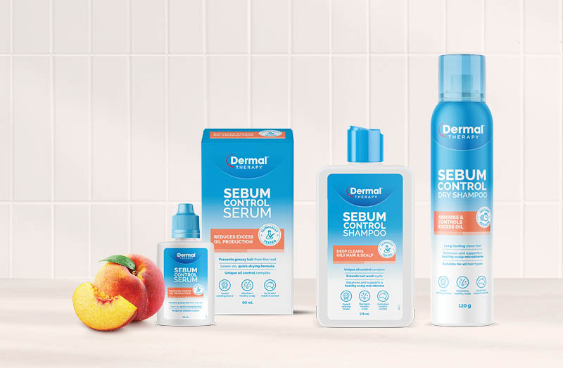 Promotional image of the Dermal Therapy Sebum Control range displaying the packaging on a benchtop with a peach, which is the scent of the range.