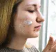 A woman applying Dermal Therapy Acne Cream wondering why Acne Doesn’t Stop in Winter And How to Treat It Without Drying Out her Skin