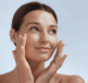 A woman with her hands on her face, applying face cream thinking about urea in moisturisers vs. other ingredients such as glycerin, hyaluronic acid, and oils