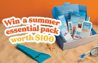 A blue gift box filled with Dermal Therapy skincare products displayed on sand with summer accessories like snorkel gear and starfish. Text overlay reads: “Win a summer essential pack worth $100.”