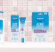 Dermal Therapy Acne Control skincare products including wash, spot cream, clear acne patch, and lotion displayed against a tiled background.