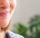 A girl smiling with a cold sore on her lip - wondering what the best cold sore treatment is?