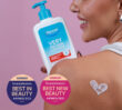 Dermal Therapy Very Dry Skin Lotion bottle held beside a shoulder with a heart-shaped cream application