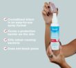 Open Dermal Therapy Crystal Deodorant Spray bottle held in hands beside visible product information text on a light blue background